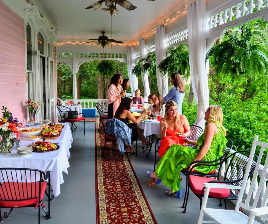 Guests having breakfast on the wraparound veranda at Cedar Crest Inn
