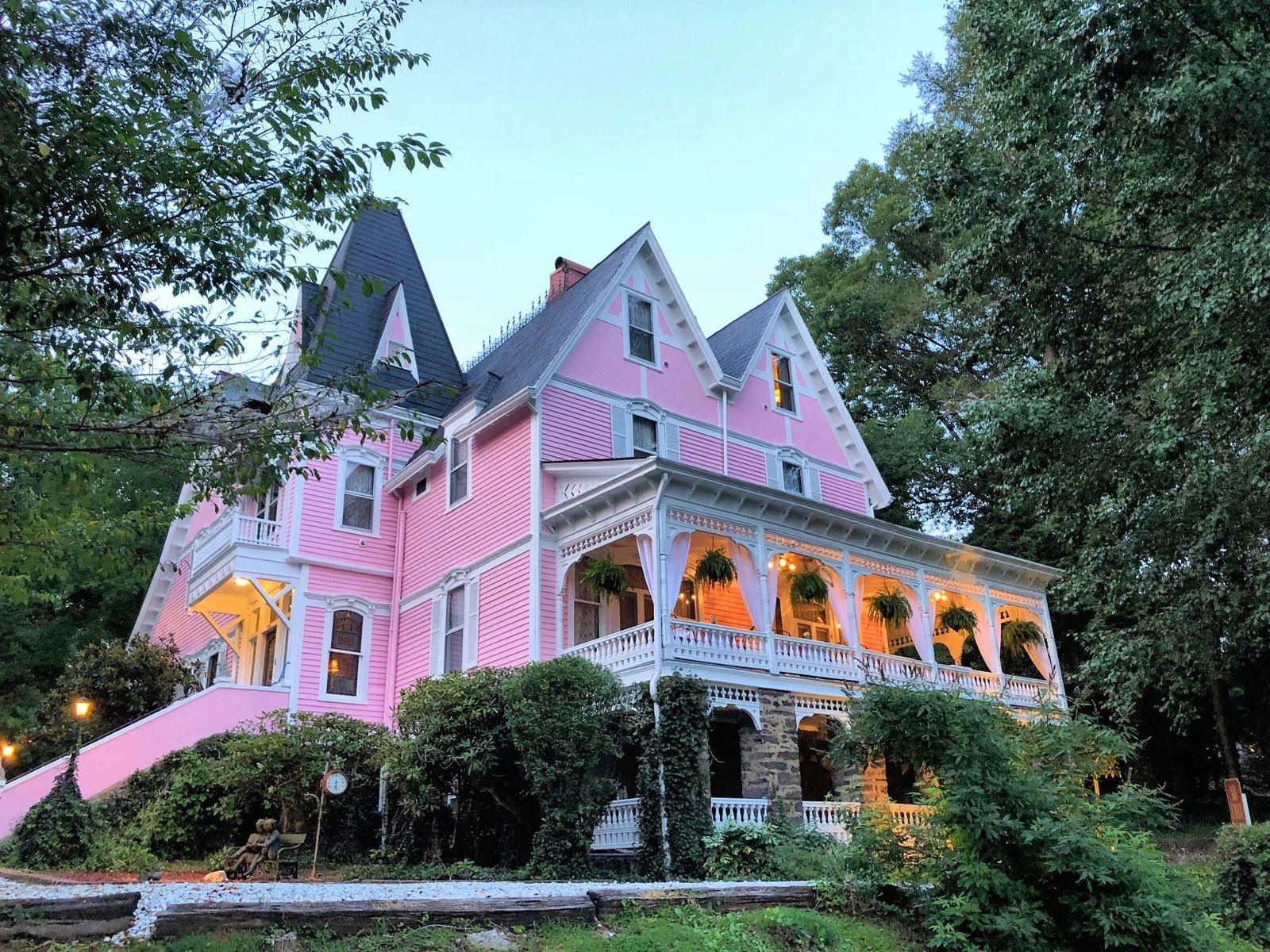 Cedar Crest Inn glowing at dusk above Biltmore Avenue