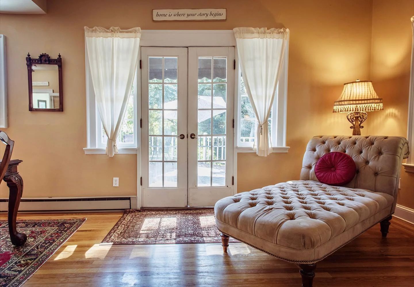 A sitting room at Cedar Crest Inn with a chaise lounge by French doors